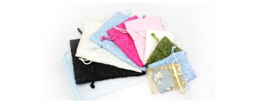 Envelopes, fabric bags, and pouches for handmade jewelry.